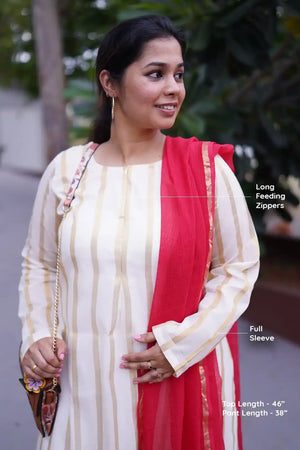 Woman wearing a white and red outfit with text labels on long feeding zippers and full sleeves.