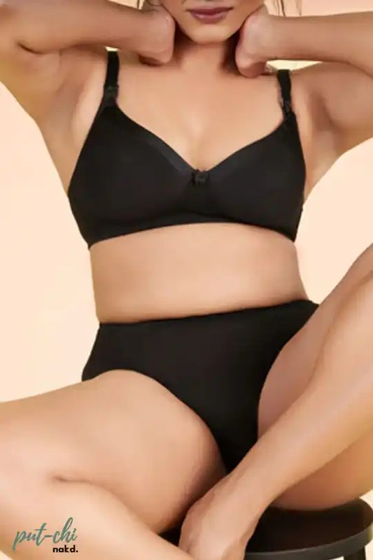 a woman is wearing a black bikini and skirt