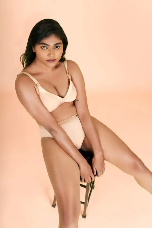 a woman in a bikini standing on a surfboard