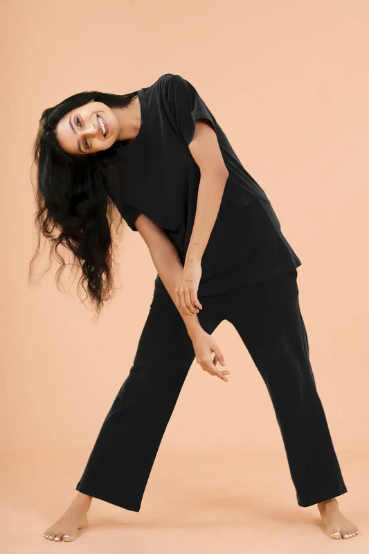 a woman in a black and white dress on a bed