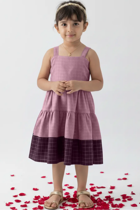 Young girl wearing a pink and purple dress with red rose petals on a white background