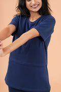 a woman holding a nintendo wii game controller 